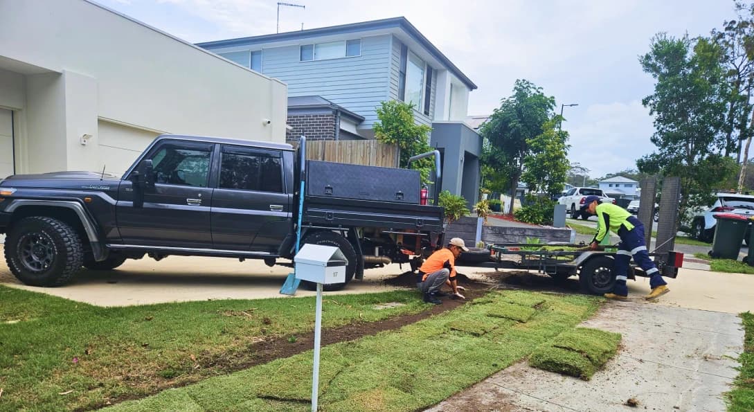 Professional garden maintenance in Brisbane — lawn mowing and edging in progress at a Logan area property